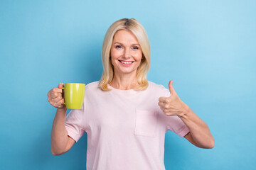 Photo of funny good mood person straight hairdo dressed white t-shirt showing thumb up approve hold...