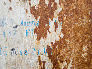 Rusty metal surface with torn poster