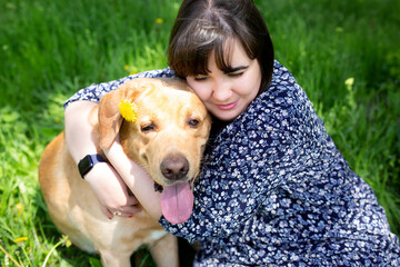 Portrait of a woman with a dog, friendship hugs with an animal