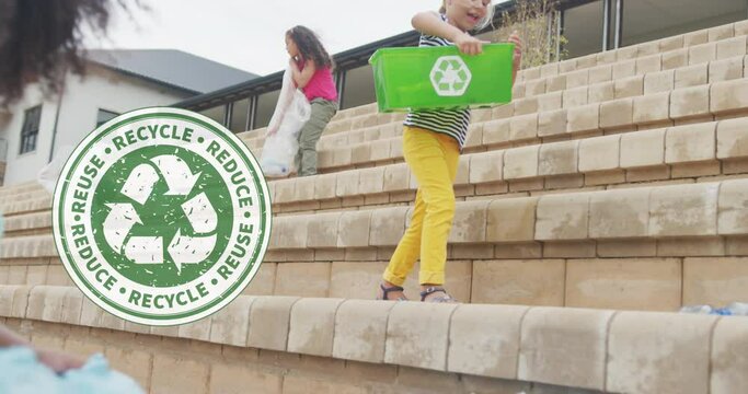 Animation of recycling logo over diverse schoolgirls collecting plastic waste outside school