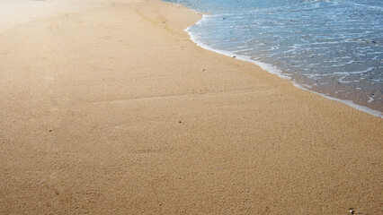 Sandy beach with the blue ocean
