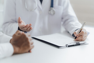 Close up view of professional physician consulting with male patient, talking to male client at medical checkup visit