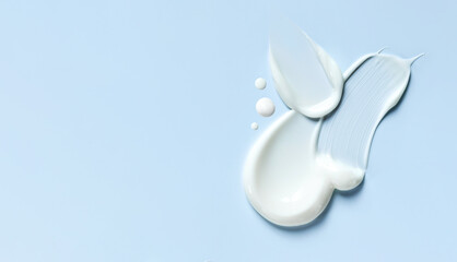 cosmetic smears of creamy texture on blue background
