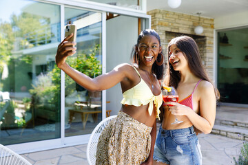 African American Girl And Her Latin Best Friend Taking A Selfie In Summer Day