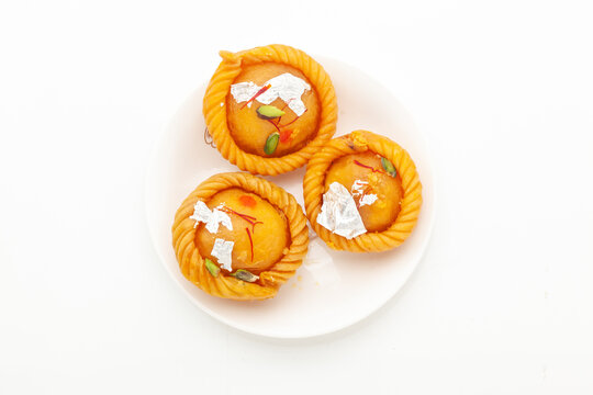 Indian traditional sweet "Chandrakala", filled with dry fruits. Top view, isolated on white.