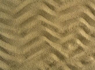 The wave pattern is drawn on the sea sand.