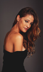 Naklejka premium Confident woman, face and beauty portrait in studio for hair care, fashion and style on a grey background. Aesthetic female model person with skin glow, cosmetics and makeup or style motivation