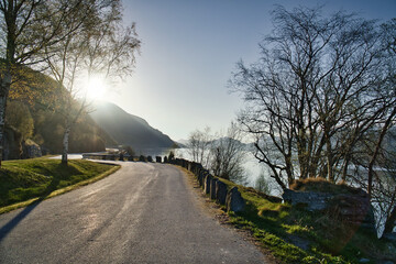 Parking lot overlooking the road, the Nordfjord and Bergen in Norway. Sun rays