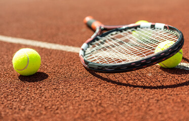 tennis racket with a tennis ball on a tennis court