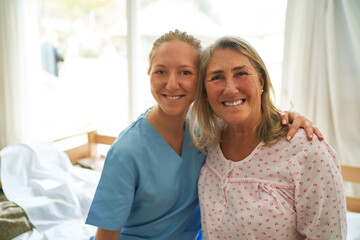 Smiling nurse with elderly woman at rehab center