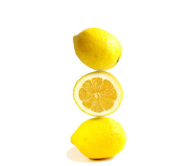 pyramid of juicy yellow lemons on a white background. Balance concept. Creative of fruits, citrus fruits.