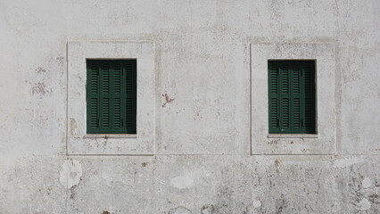 Fototapeta na wymiar rustic windows on white facade