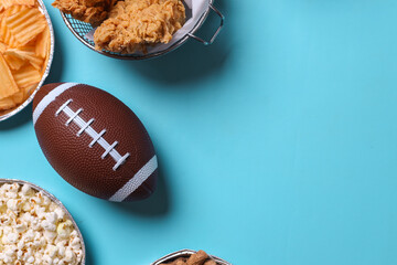 Top view of snacks for watching a football game. Super Bowl or Playoff concept on blue background with copy space.
 - obrazy, fototapety, plakaty