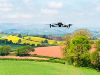 Drone in flight over fields and farms, Devon, England
