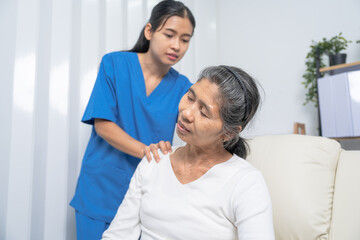 Fototapeta premium Female asian physiotherapist worker giving neck massage to mature woman, closeup. Rehabilitation physiotherapy in rehabilitation center, neck pain