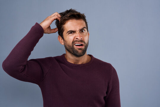 Doubt, confused and portrait of man with puzzled, uncertain and scratch head on gray background. Thinking, mockup space and face of male person worried for decision, choice and question in studio