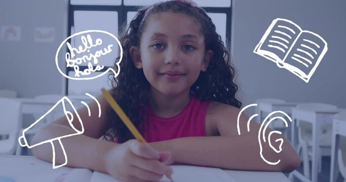 Animation of language and communication icons over happy biracial schoolgirl working at desk - Powered by Adobe