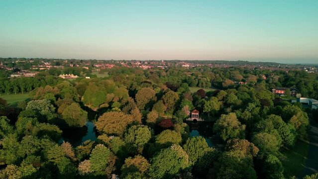 Birkenhead Park, upon which Central Park NY is based - Aerial drone at dawn, clockwise rotate, Liverpool skyline reveal - May 23