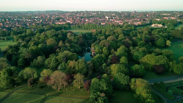 Birkenhead Park, upon which Central Park NY is based - Aerial drone at dawn, slow anti-clockwise rotate, Liverpool skyline reveal - May 23