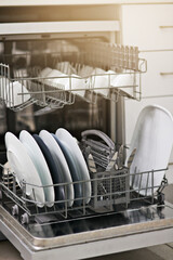 Backgrounds, dishwasher and machine for cleaning dishes, washing, dirty kitchenware and easy housekeeping process. Closeup of electrical appliance with plates, cups and crockery for hygiene at home