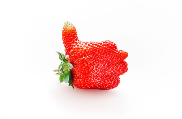 Unusual strawberry in the shape of hand with thumb up similar the like sign, beige background, top view