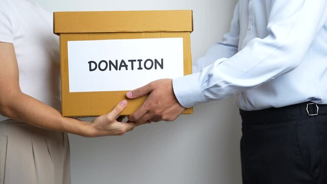 Donation, Charity, Volunteer, Giving and Delivery Concept. People donate Clothes and Food into Donation box at home or office for support and help poor, refugee and homeless people. Copy space