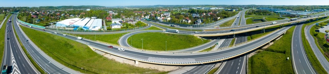 Krakow, Poland. Wide aerial panorama of highway multilevel spaghetti junction with ramps, slip roads, viaducts, cars, trucks and  traffic