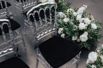 Reception. Chairs for guests decorated with beautiful floral arrangements for wedding ceremony.