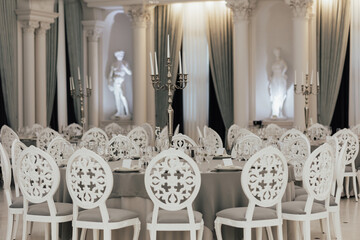 Served table for wedding ceremony, decorated with candles in the luxury restaurant.