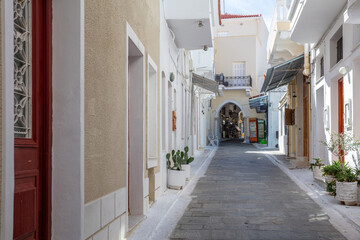Andros island, Chora town, Cyclades Greece. Paved alley, house wall, souvenir shop Greek art.
