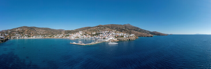 Andros island, panorama of Batsi village, Cyclades Greece. View from ship of port, sea, sky. Banner