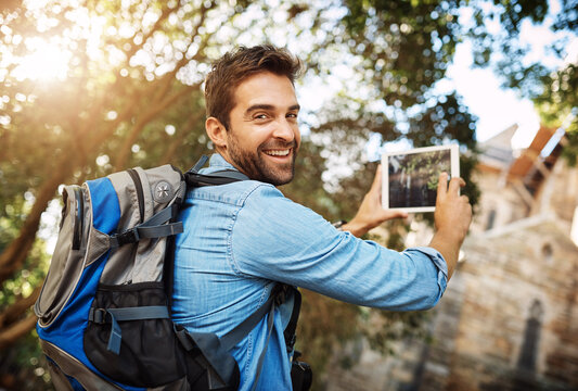 Man, tourist and tablet for travel photo outdoor in nature with a backpack and smile. Portrait of male person with tech for hiking adventure, journey or vacation photography and freedom or happiness