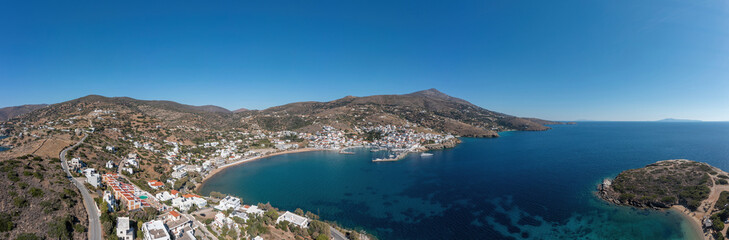 Naklejka na ściany i meble Andros island, of Batsi village, Cyclades Greece. Aerial drone panoramic view of landscape. Banner