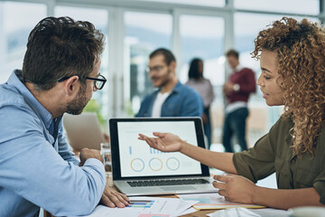 Laptop, finance and graph with a business team doing research together in their office for...