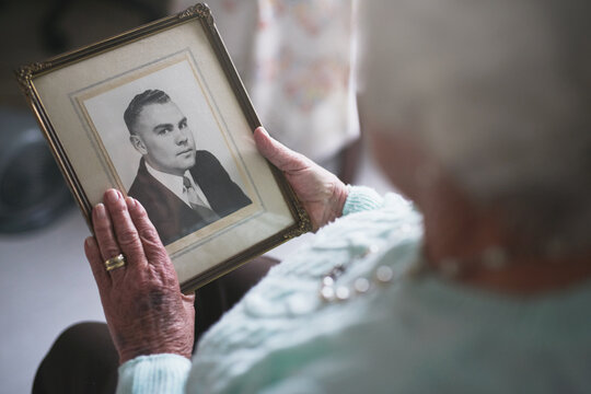 Senior woman, picture frame and memory of husband for nostalgia, history and mourning death. Closeup, elderly and lonely widow with photograph of partner to remember memories, love and grieving