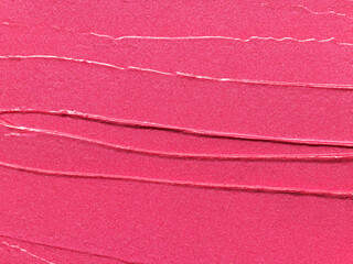 Pink lipstick shimmering texture, full frame texture background. Cosmetic product swatch