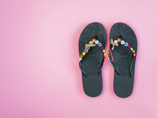 pair of flip flops isolated on pink background. Close-up of beach slippers. Future vacation. blank for design. horizontal image