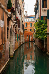 Fototapeta na wymiar Cozy narrow canals of Venice city with old traditional architecture and bridges, Veneto, Italy. Tourism concept. Architecture and landmark of Venice. Cozy cityscape of Venice.