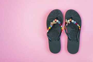 pair of flip flops isolated on pink background. Close-up of beach slippers. Future vacation. blank for design. horizontal image