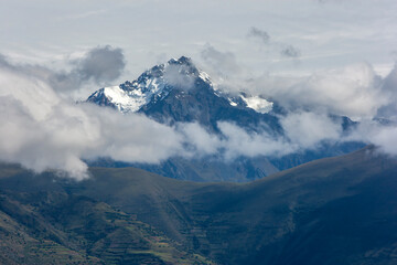 A view of a spectacular snow capped peak in the Andes Mountain range as seen from Maras in Peru. Maras is a town in the Sacred Valley of the Incas, 40 kilometers north of Cusco.