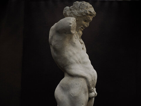 Ancient statue of Priapus symbol of the fertility of ancient Rome isolated on blACk