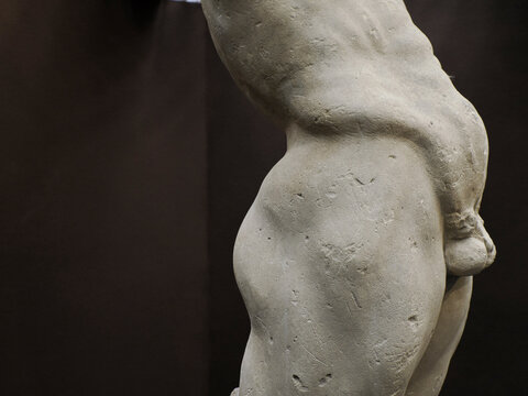Ancient statue of Priapus symbol of the fertility of ancient Rome isolated on blACk