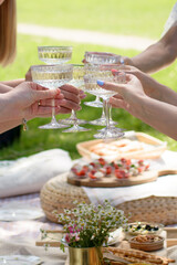 Girls celebrating in nature with beautiful glasses of champagne