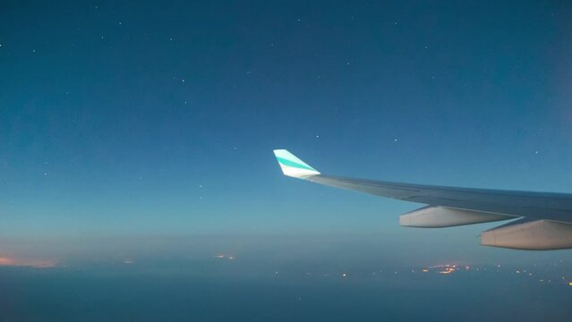 Timelapse taken from the airplane window, from the sunset to the night sky. Stars from the window of the airplane. Airbus A330.