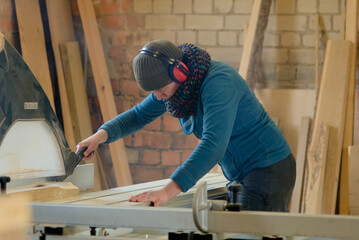 Carpenter sawing wood. man working with wood