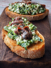 Toast with cottage cheese or ricotta, anchovy and herbs