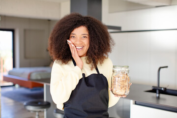 pretty afro black woman feeling happy and astonished at something unbelievable. homemade cookies concept