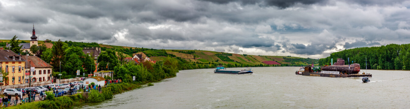 Nierstein, Germany, May 16 2023: TRANSPORT HISTORY. Panoramic view of U17 submarine of the German Navy on River Rhine. eager spectators. crowd of curious guests waiting anxiously. Transport to Museum