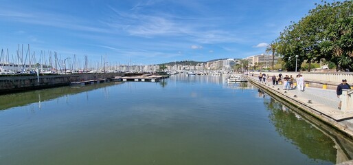 Fototapeta premium Port of Palma, is a bustling maritime hub located in the capital city of Mallorca, Spain. It serves as a major point of entry for cruise ships, yachts, and ferries, attracting a significant number of