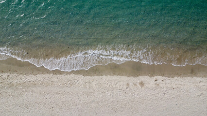 Waves on the beach. Aerial view of a sandy beach and small waves.